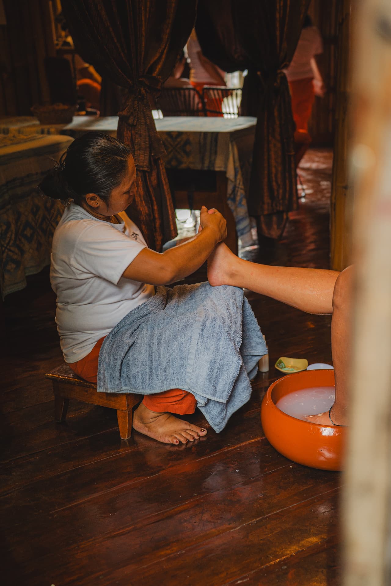 A trained therapist giving a foot massage